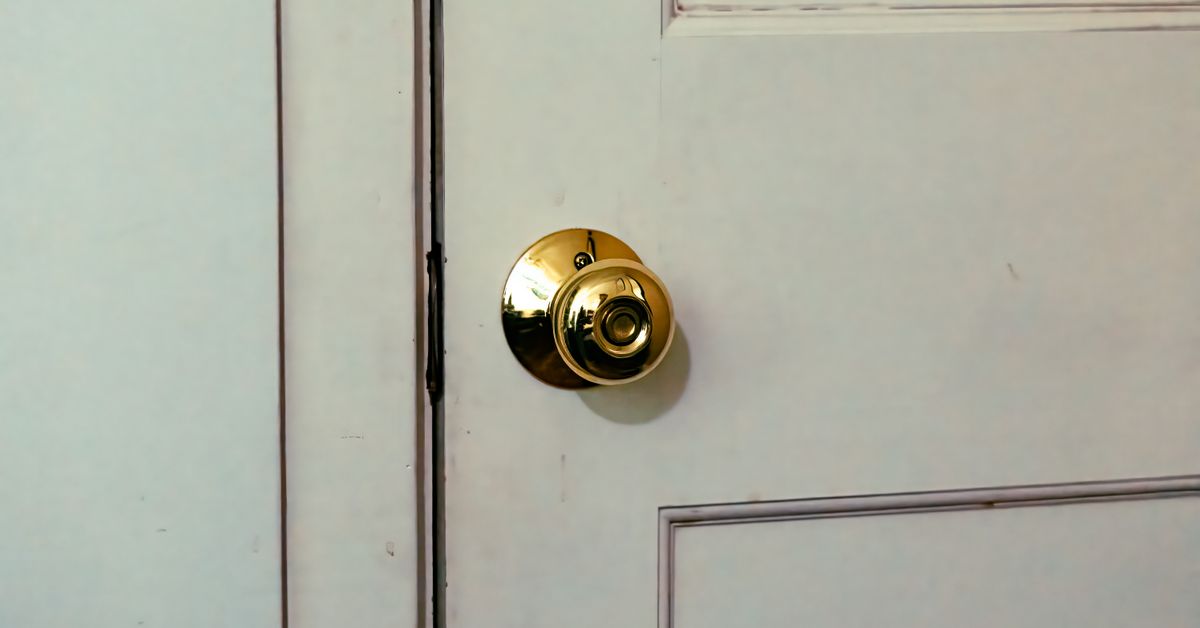 Door sex swing guide - close-up of a classic white door and brass knob, from Red Pleasures