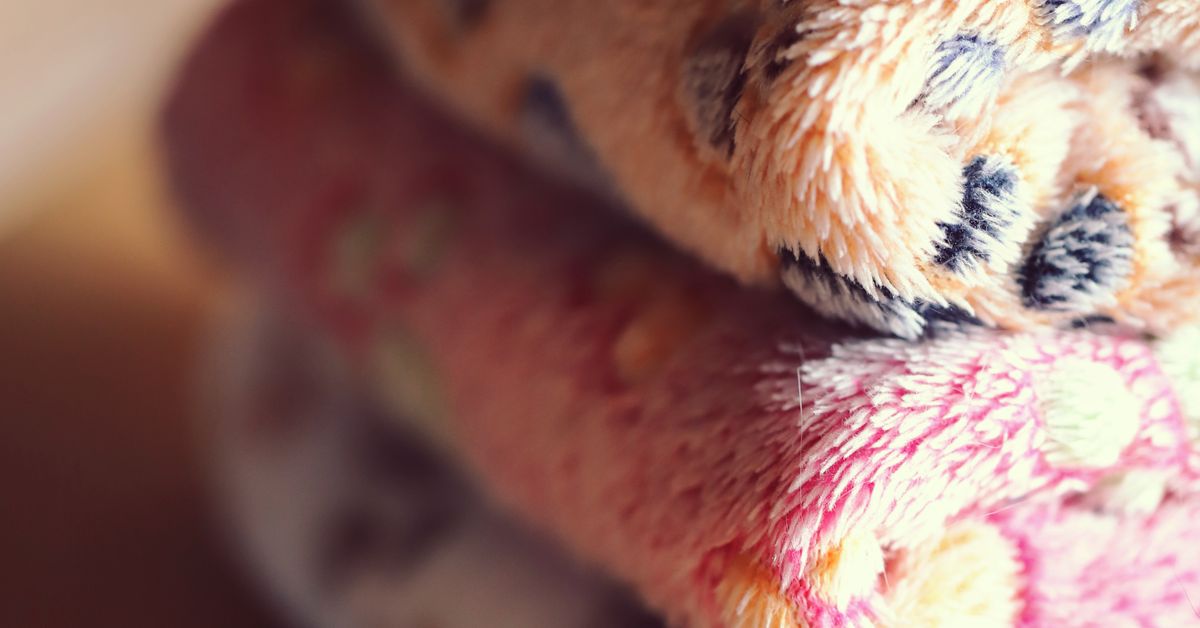 Subspace and aftercare in BDSM — a stack of folded wool blankets, a Red Pleasures education guide