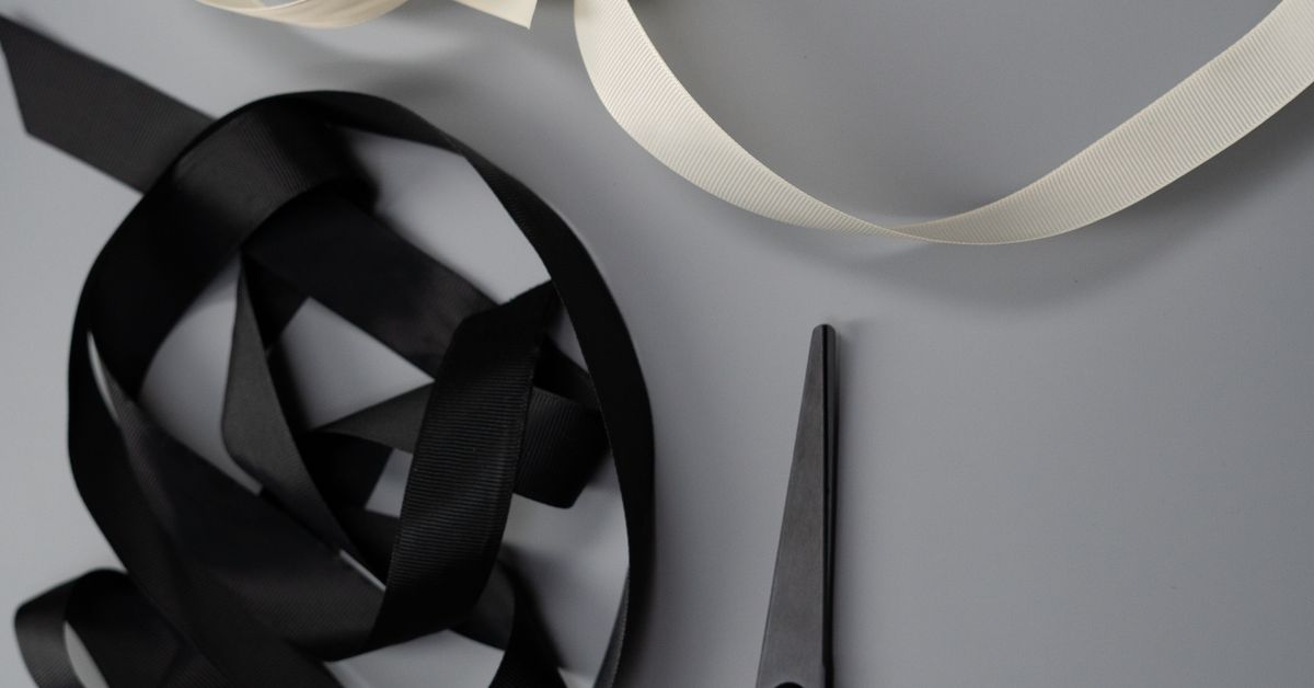 Bondage tape guide — safety shears beside coiled tape on a flat surface, from Red Pleasures