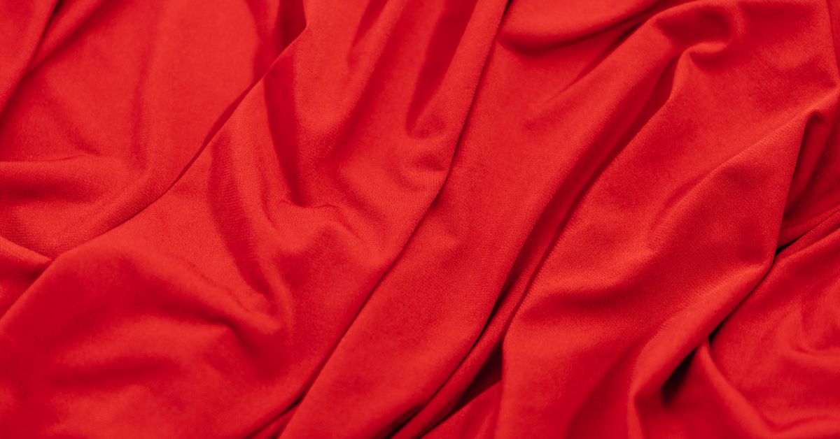 How to use a cock ring — red silk satin fabric still life, beginner guide from Red Pleasures Canada