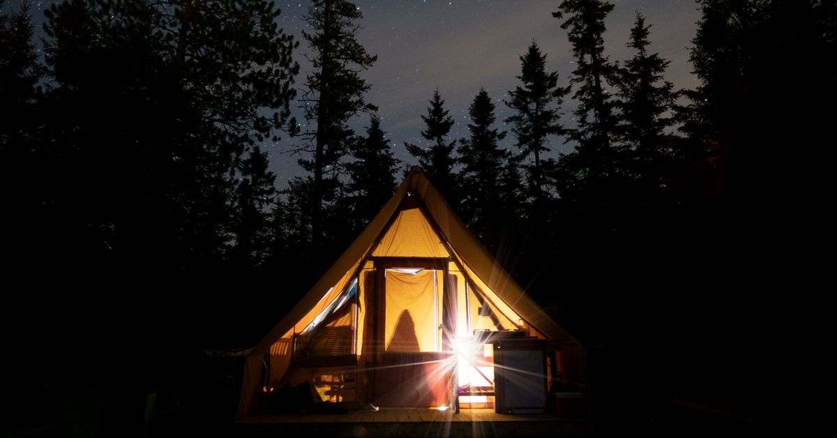 Outdoor sex in Canada guide — secluded tent glowing at night in a Quebec forest