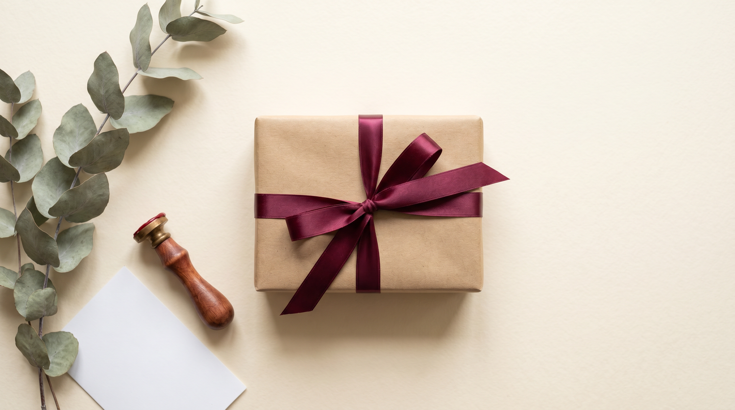 Plain kraft-paper parcel tied with a burgundy ribbon — discreet packaging used by Red Pleasures for Canada-wide shipping
