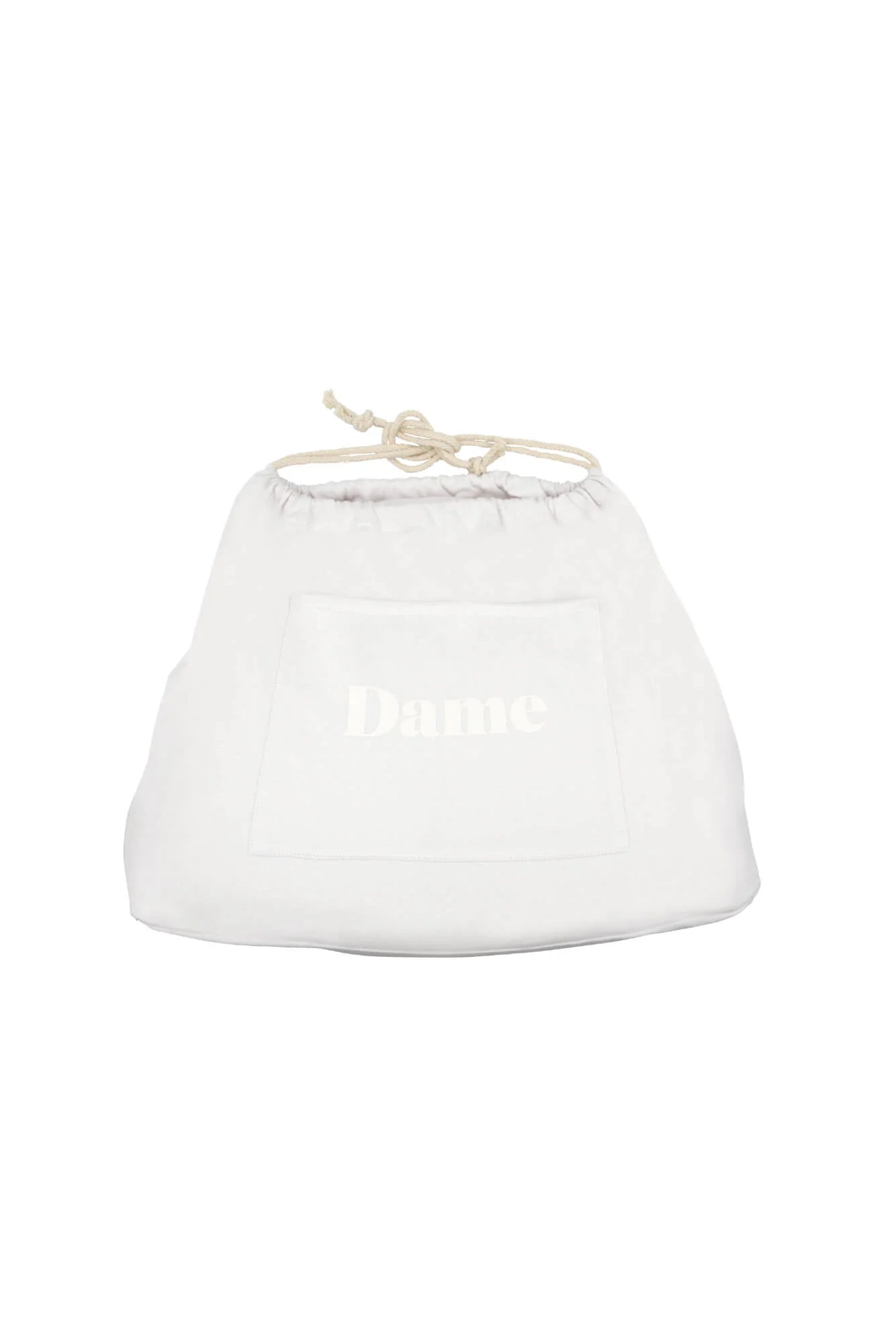A white drawstring bag with the word "Dame" printed on a patch.