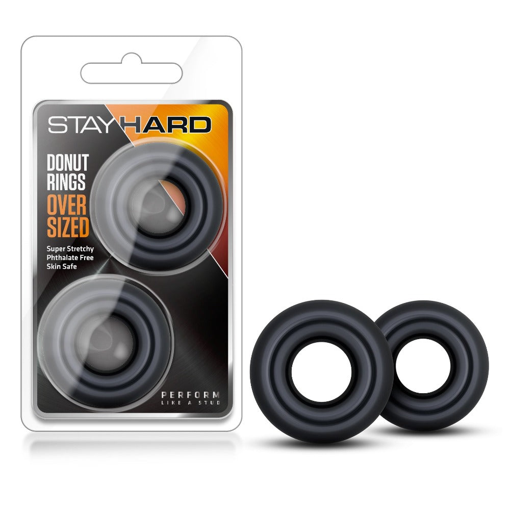 Two black, oversized donut-shaped cock rings are shown.