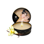 Vanilla scented massage oil candle with a floral garnish.
