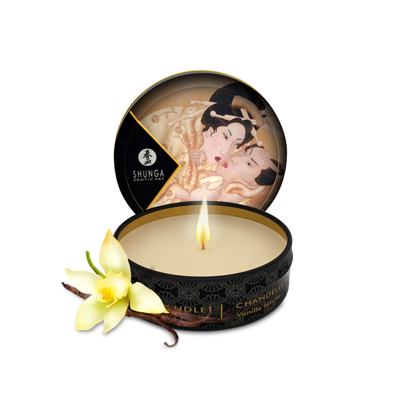 Vanilla scented massage oil candle with a floral garnish.