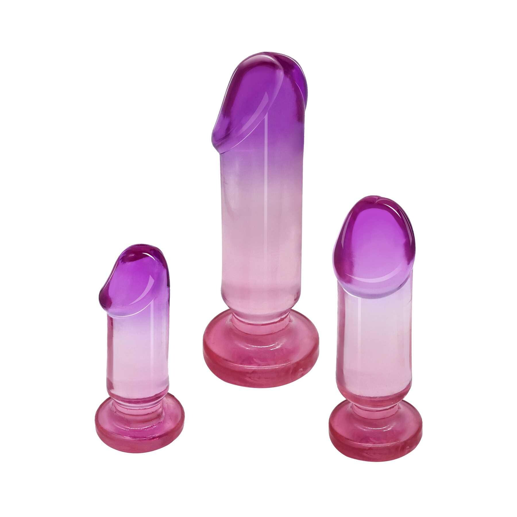 Three graduated purple and pink anal plugs with flared bases.