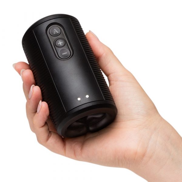 Black vibrating masturbator held in a hand.