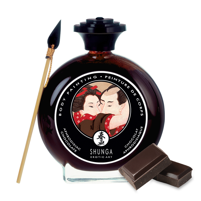 Edible chocolate body paint with a wooden applicator and two chocolate squares.