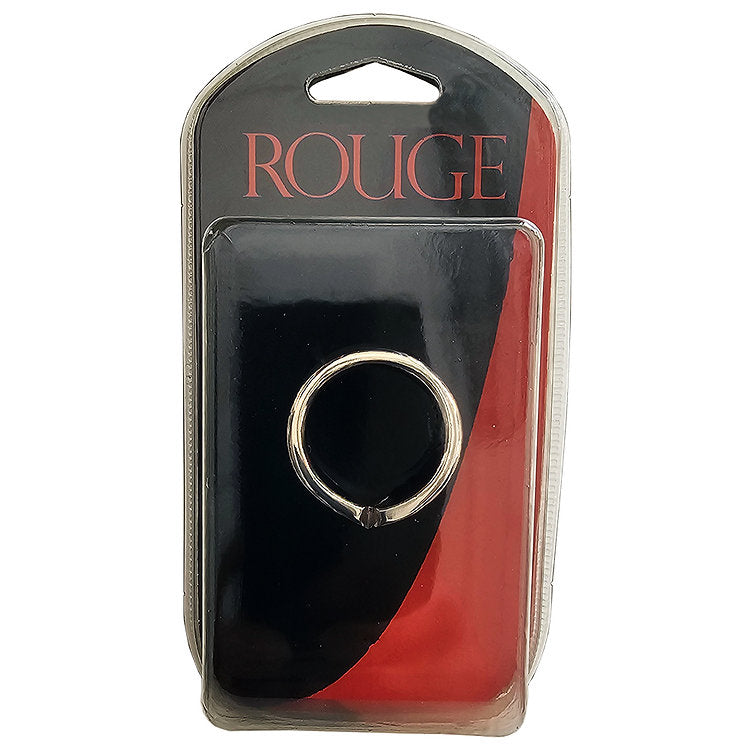 A stainless steel cock ring with a crown design, packaged in a blister pack with "ROUGE" branding.
