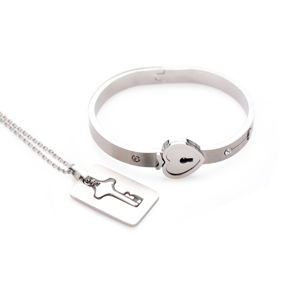 Silver-tone bracelet with a heart-shaped lock and a matching key pendant necklace.
