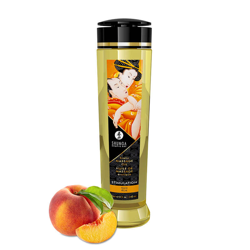 Shunga Stimulating Peach Massage Oil with a peach and slice of peach.