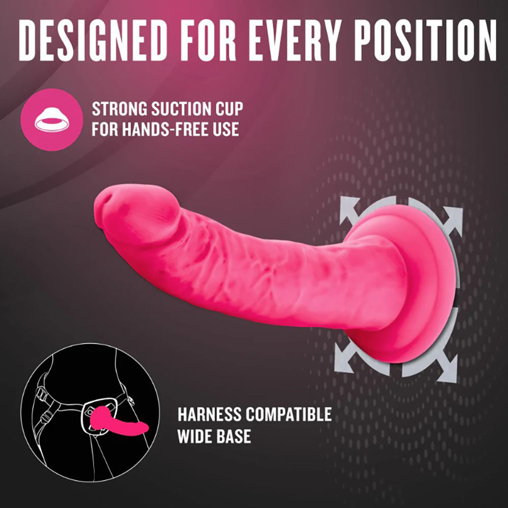 Neon pink dual density silicone dildo with suction cup base and harness compatibility.