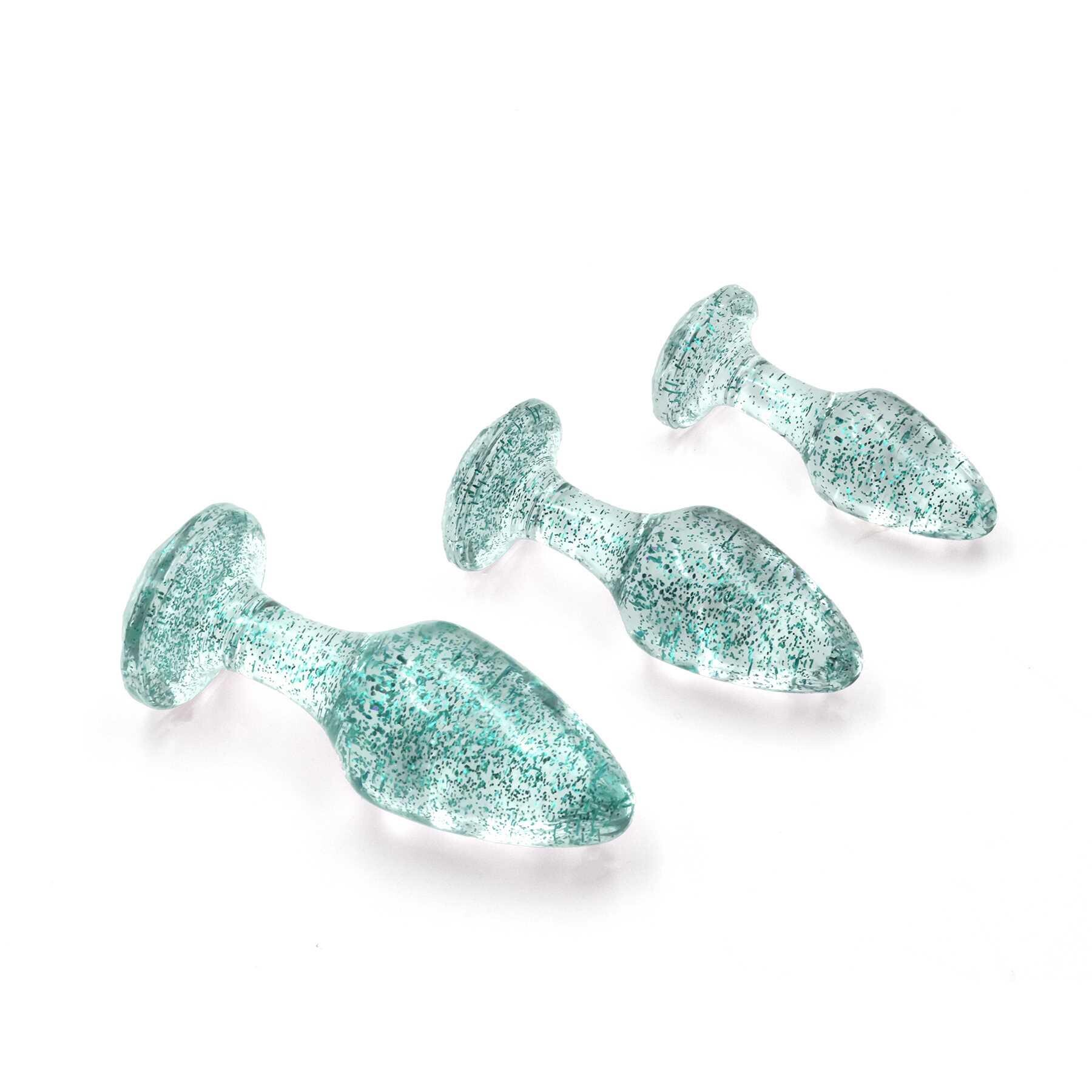 Three blue glitter anal plugs with gem-shaped bases.