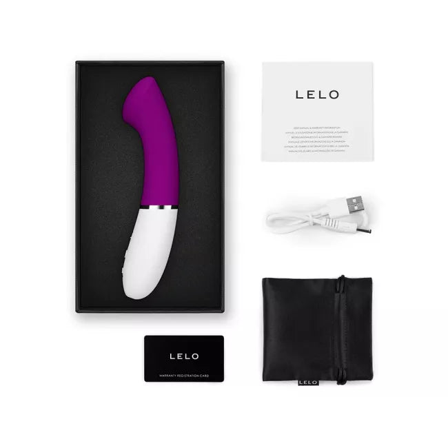 Purple and white G-spot vibrator with charging cable, manual, and storage pouch.