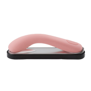 Pink curved silicone vibrator on a charging base.