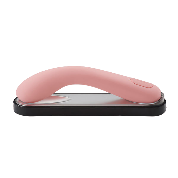 Pink curved silicone vibrator on a charging base.