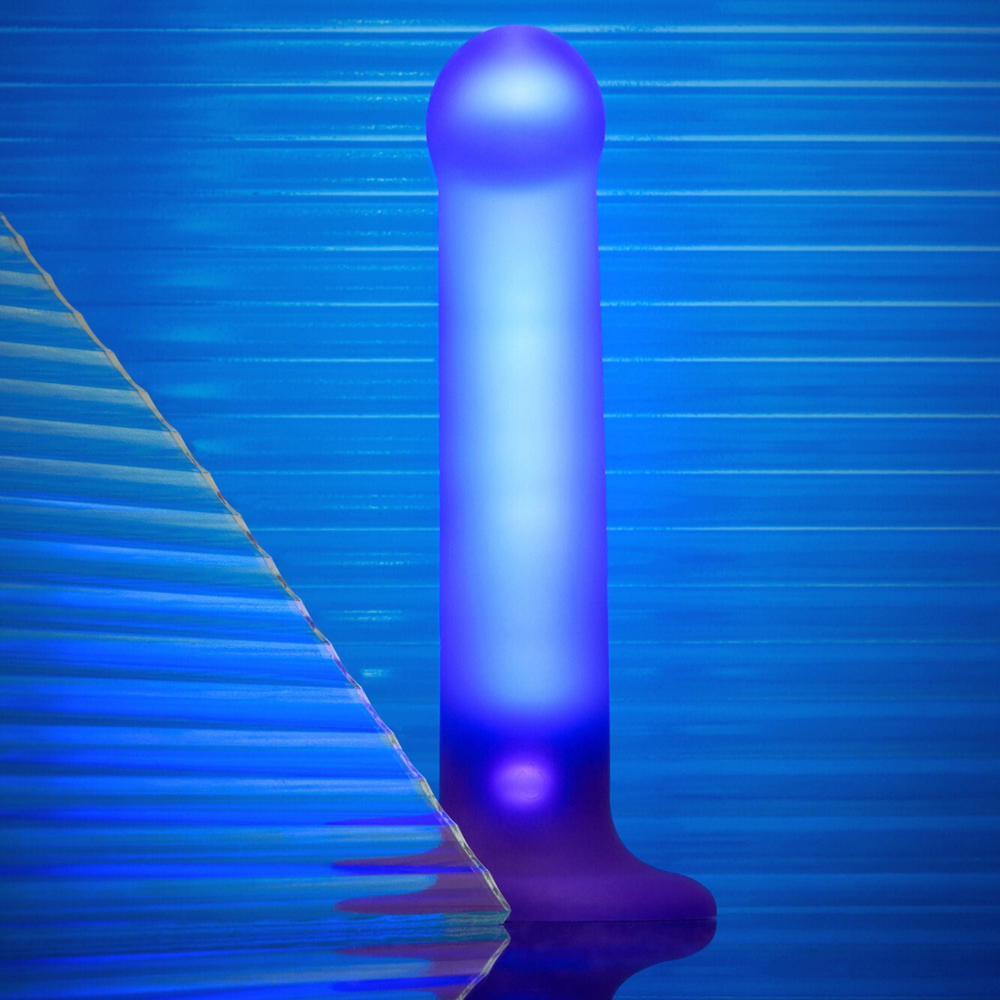 A purple silicone dildo with a glowing LED light and a textured triangular element.