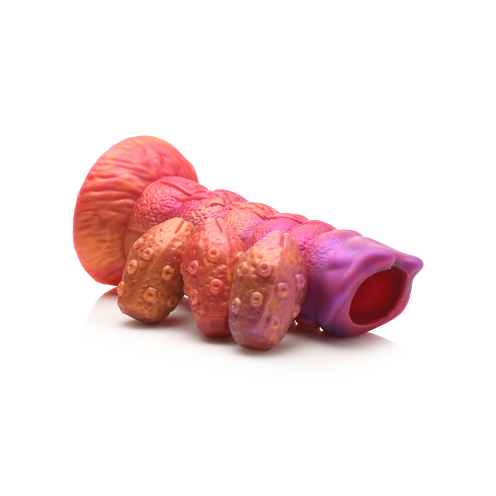 Fantasy dildo with segmented ribs, open head, and three silicone eggs.