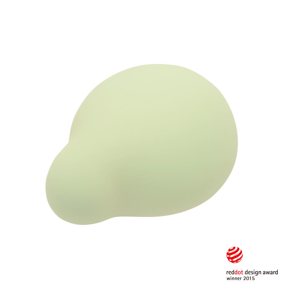 A light green, rounded silicone vibrator with a Red Dot Design Award logo.