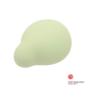 A light green, rounded silicone vibrator with a Red Dot Design Award logo.