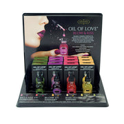 Kama Sutra Oil of Love body oil display set with four tester bottles.