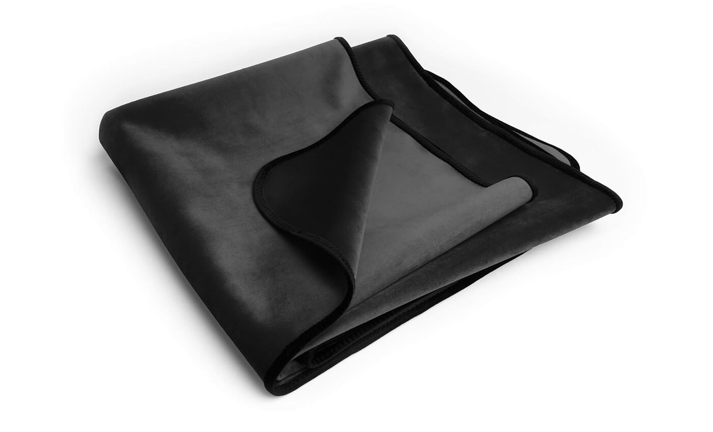 Black waterproof microvelvet throw blanket folded.