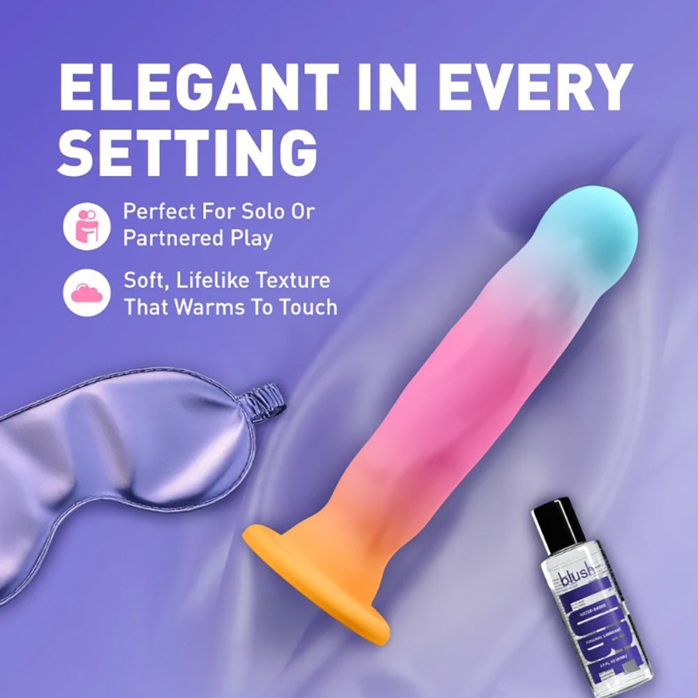 A gradient silicone stimulator with a satin eye mask and lubricant bottle.