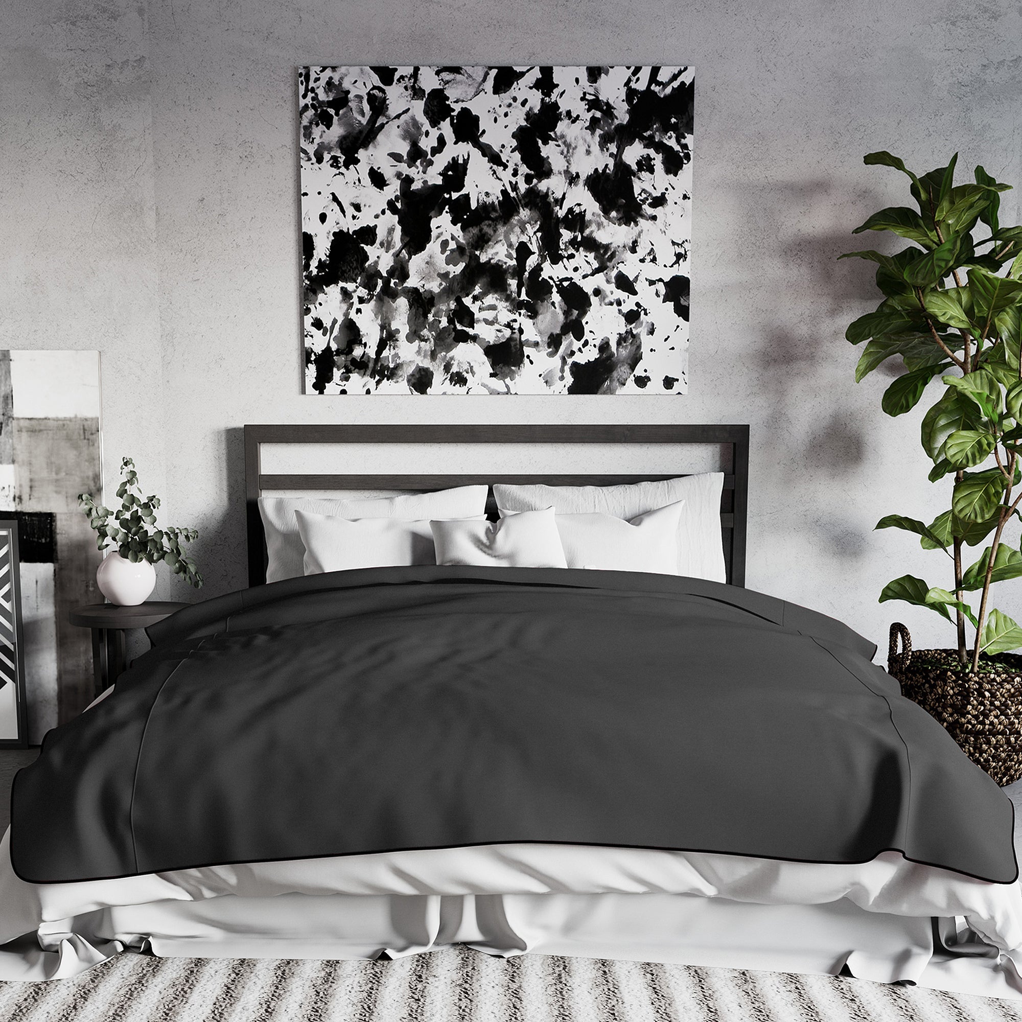 King size black waterproof microvelvet throw blanket on a bed.