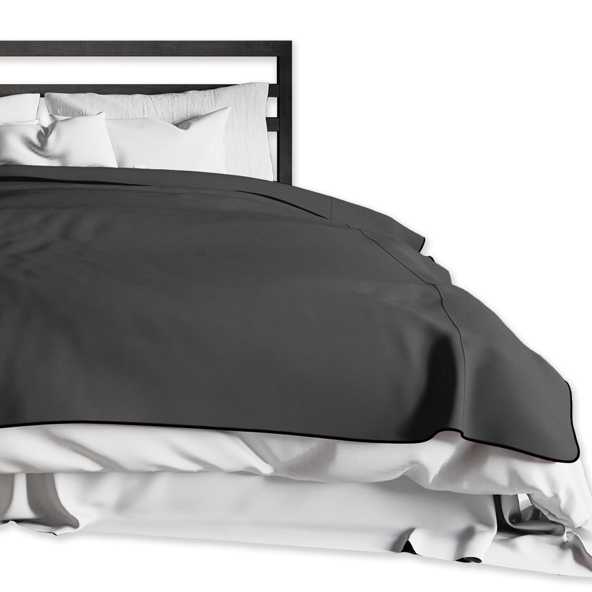 King size black waterproof microvelvet throw blanket on a bed.