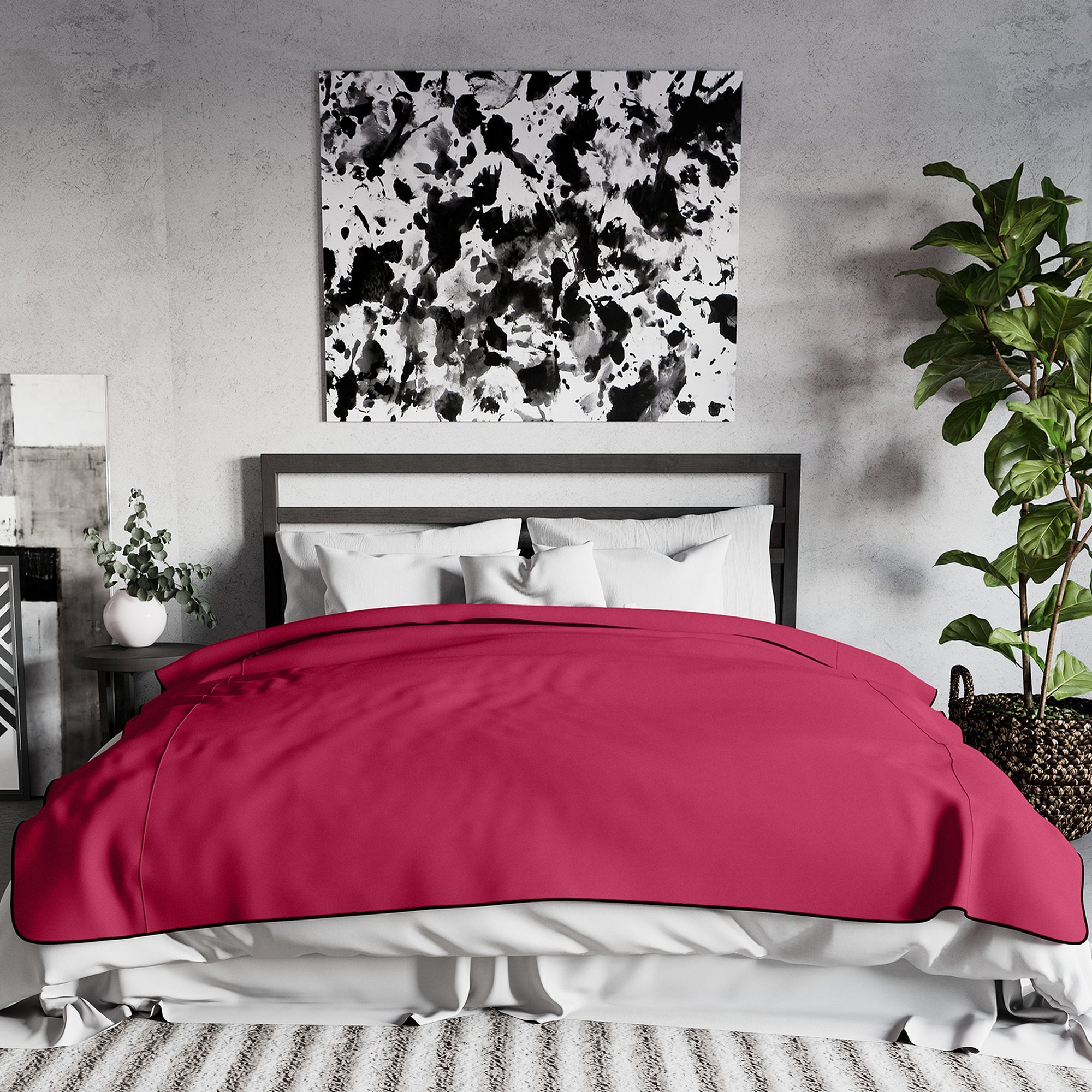 A king-size Merlot waterproof microvelvet throw blanket is draped over a bed.