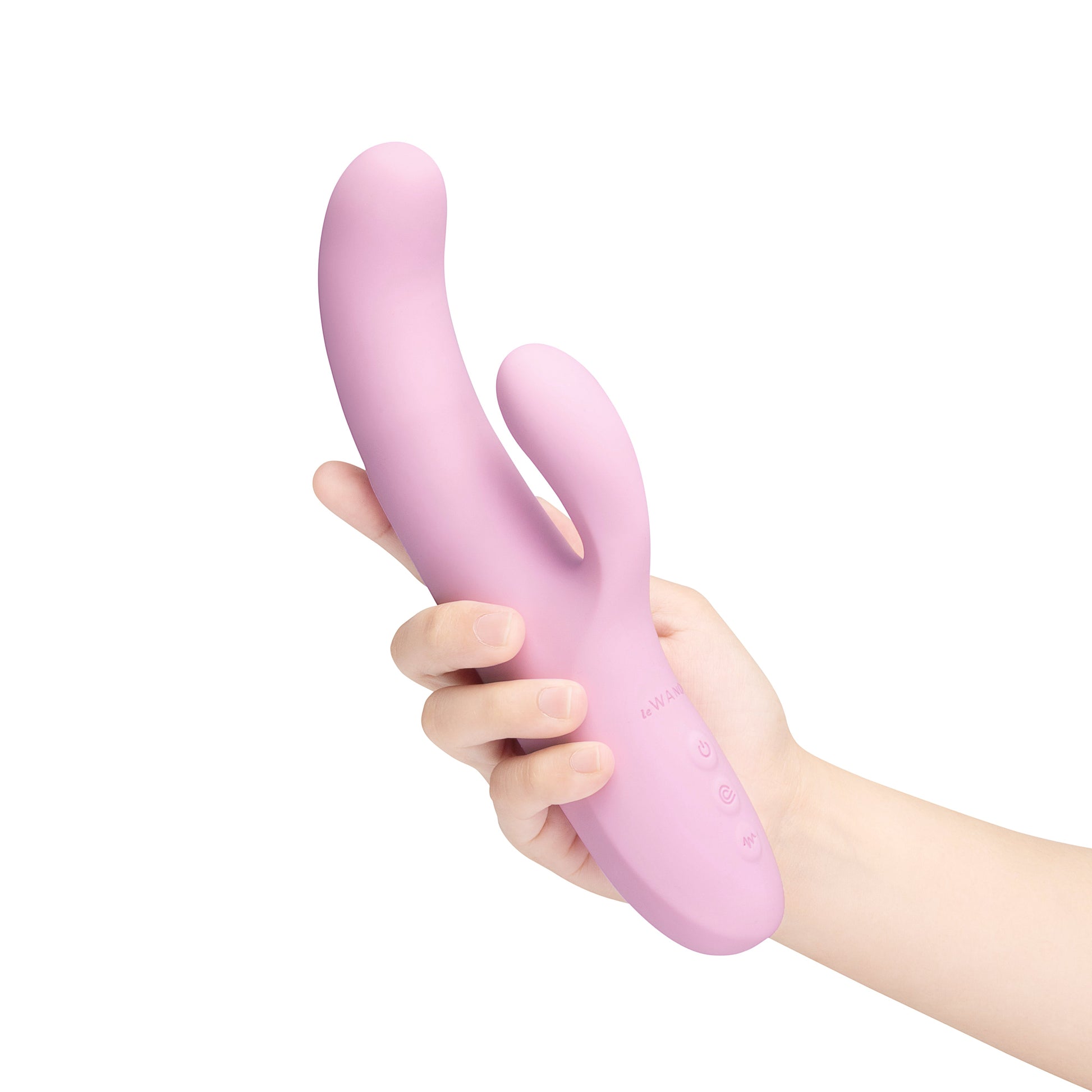A pink rabbit-shaped vibrator held in a hand, with buttons visible.