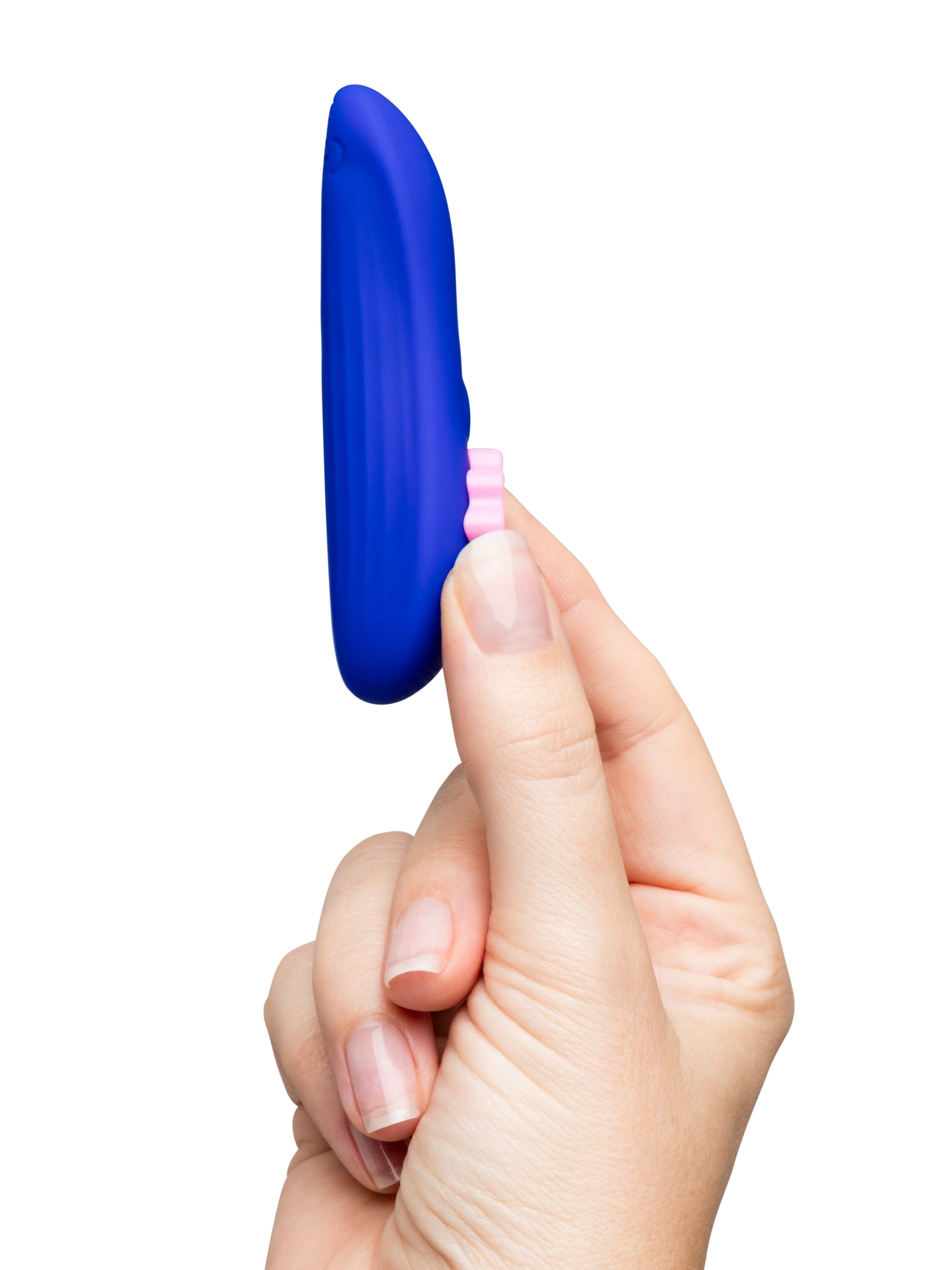 A hand holds a blue remote control panty vibrator with a pink button.