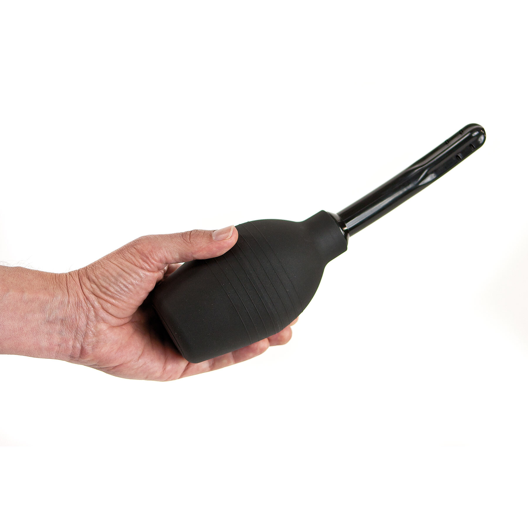 A black anal douche with a flexible tip and a flat base held in a hand.