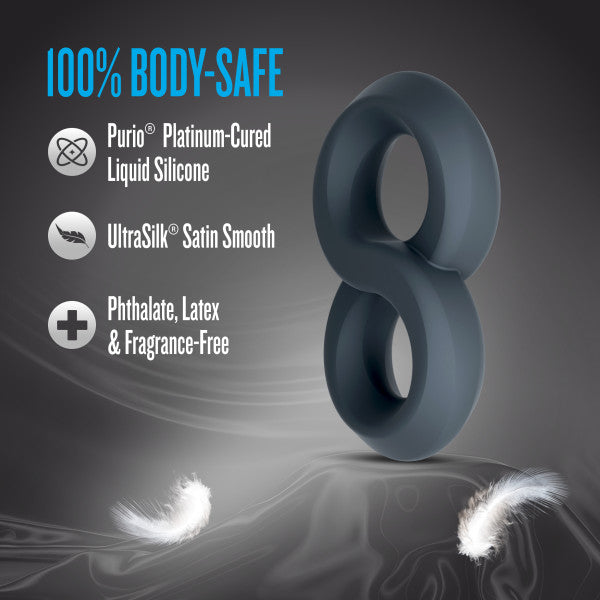 A dark grey, figure-eight shaped silicone cock ring with text about body-safe materials.