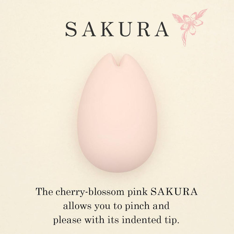 A pink, egg-shaped vibrator with an indented tip, labeled SAKURA.