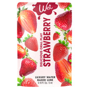 Wet Strawberry flavored personal lubricant packet with strawberries.