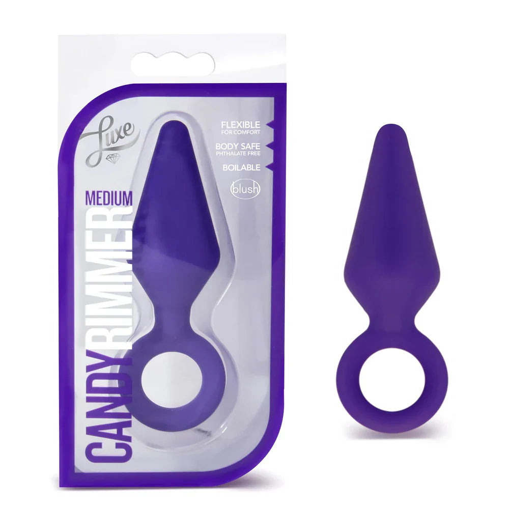 A purple medium silicone anal plug with a ring, shown in packaging and alone.