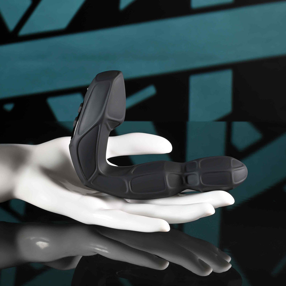 Black remote-controlled prostate massager with a twirling head on a white hand mannequin.