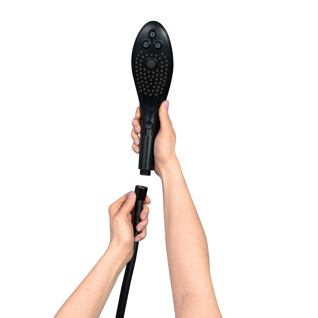 Black shower head with a hose attachment being connected.