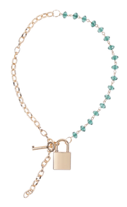 Gold chain necklace with green beads, a lock, and a key.