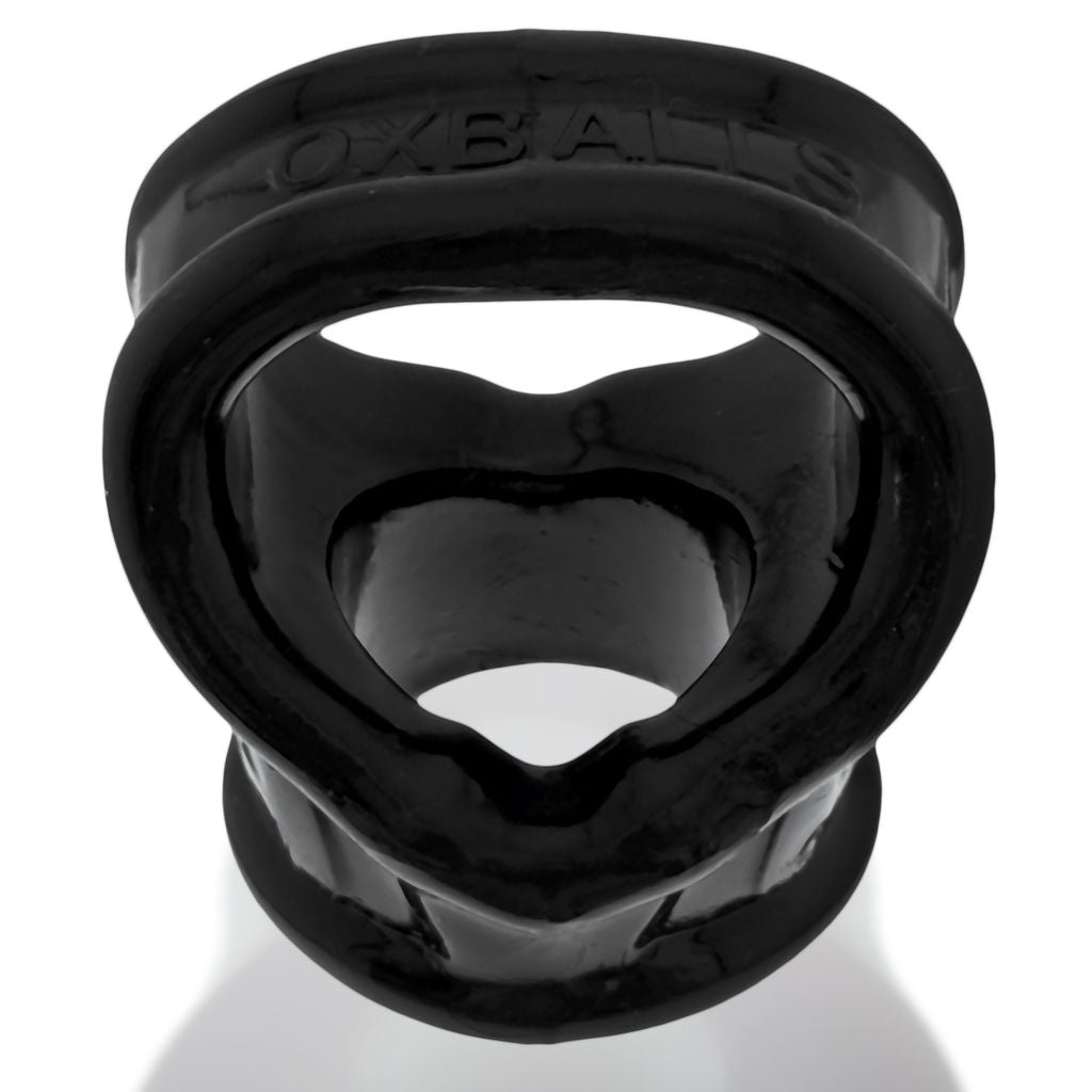 Black rubber cock ring sling with heart-shaped opening and "OXBALLS" embossed on the top band.