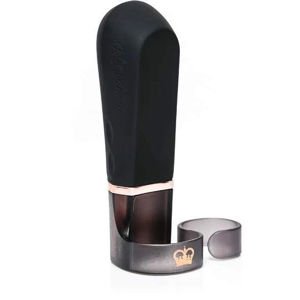 Black wearable finger vibrator with rose gold accents and a charging stand.