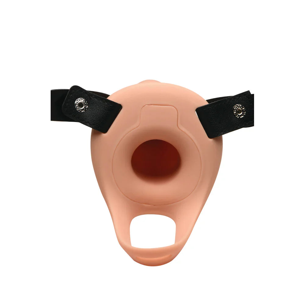 A peach-colored silicone penis sheath with black straps and metal snaps.