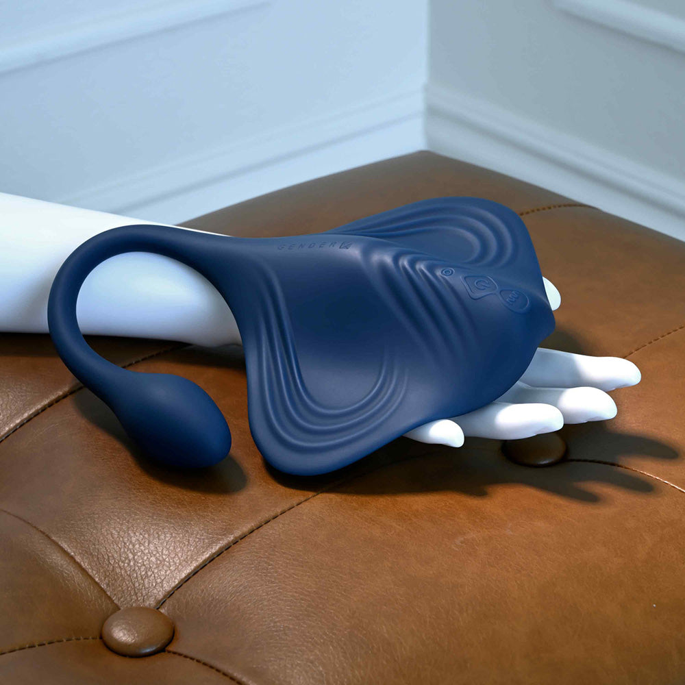 A blue silicone stingray-shaped massager with a tail attachment.