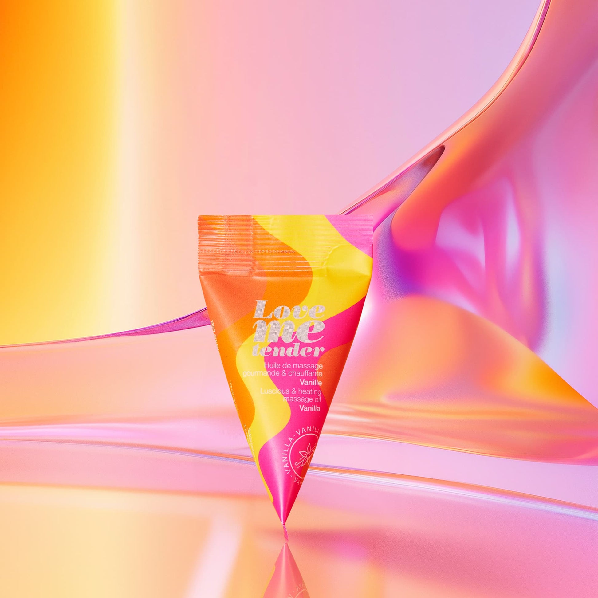 A tube of "Love me tender" vanilla massage oil with a colorful design.