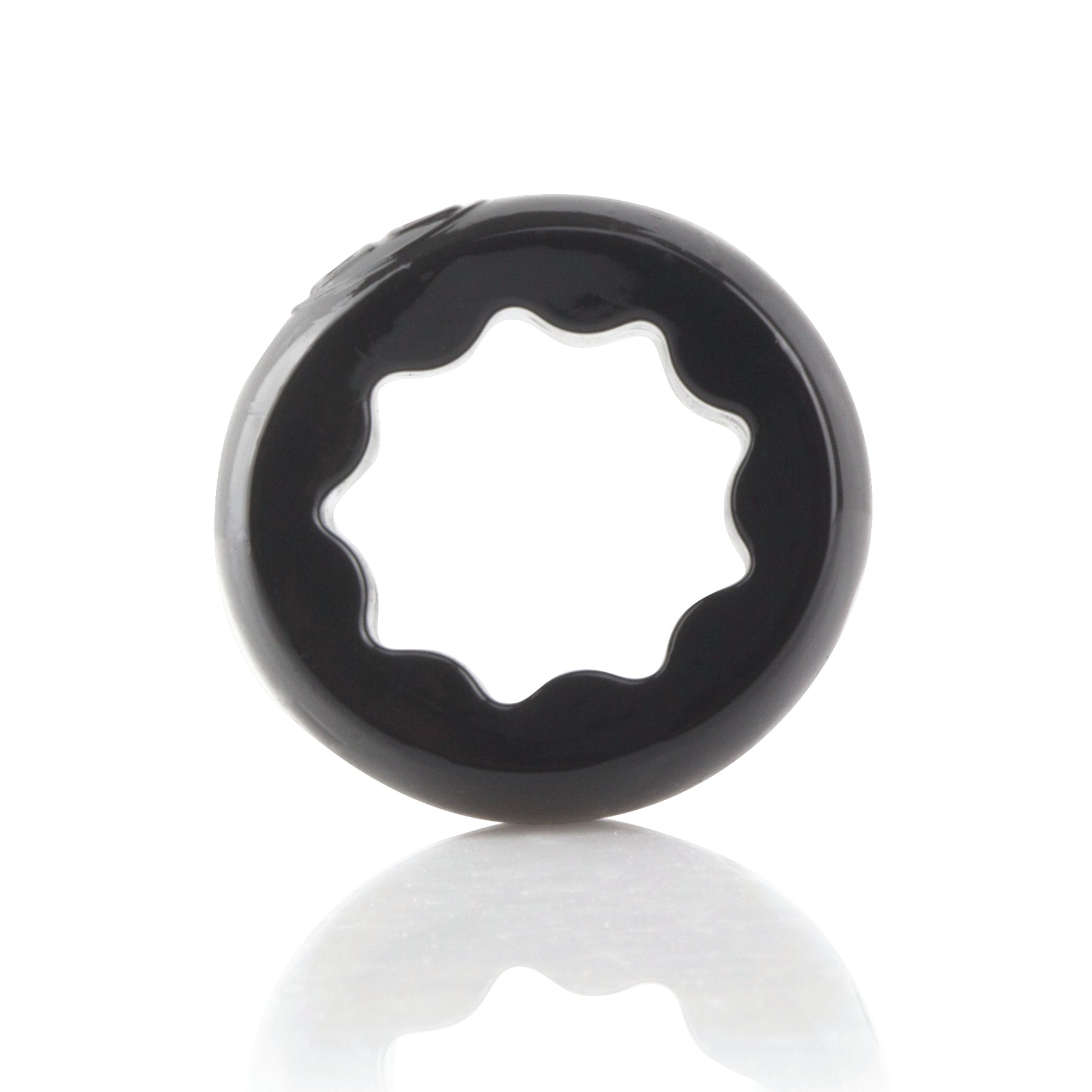 A black, star-shaped penis ring with a reflective surface.