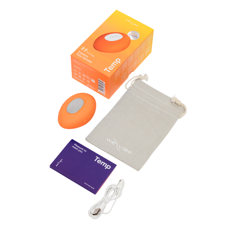 We-Vibe Temp lay-on vibrator in tangerine with charging cable and storage pouch.