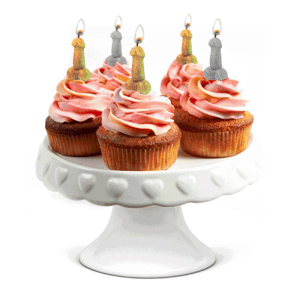 Glitter penis candles in gold and silver on cupcakes.