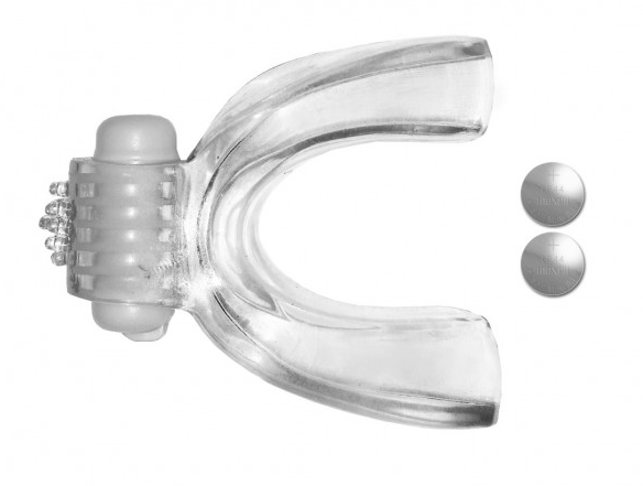Clear vibrating oral stimulator with textured bumps and two button batteries.